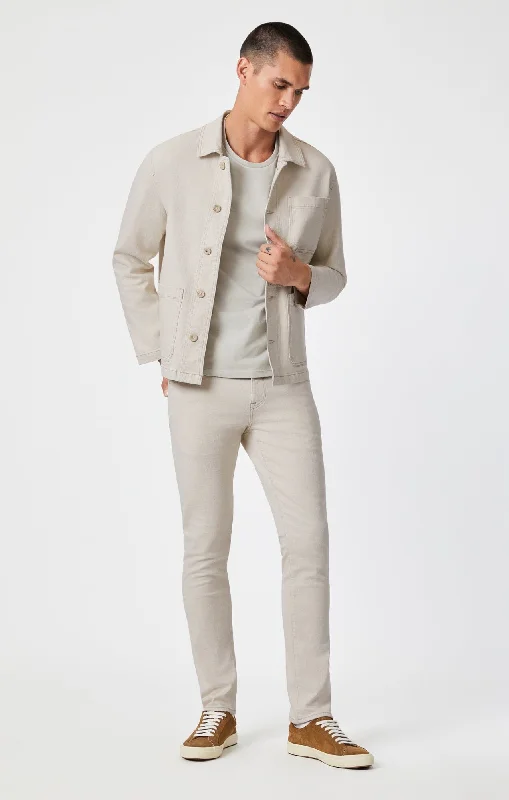 Men's Low - Rise Jeans in a Light Wash for a Casual and Youthful LookJAKE SLIM LEG IN NATURAL ECRU DENIM Men's Low - Rise Jeans in a Light Wash for a Casual and Youthful LookJAKE SLIM LEG IN NATURAL ECRU DENIM