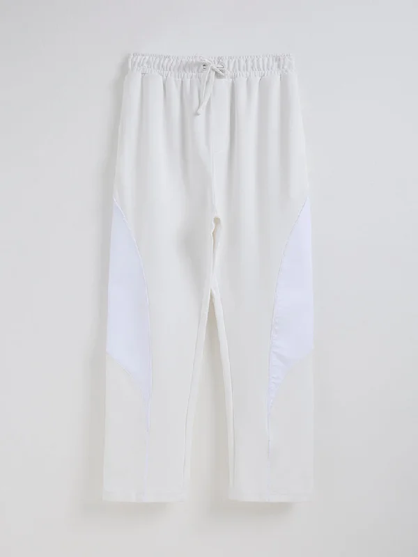 Men's distressed cotton shorts for a bohemian - inspired styleStudiofit Off-White Relaxed-Fit Mid-Rise Track Pants Men's distressed cotton shorts for a bohemian - inspired styleStudiofit Off-White Relaxed-Fit Mid-Rise Track Pants